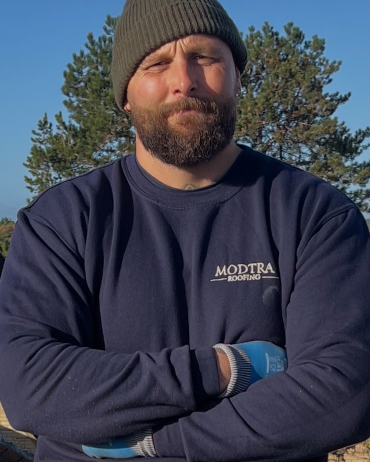 Duncan Soden, owner of Modtra Roofing, on site in his Modtra Roofing jumper