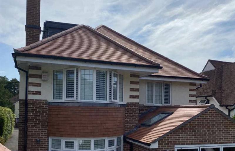 Completed tiled re-roof on a detached Ringwood house with a curved tile-hung bay